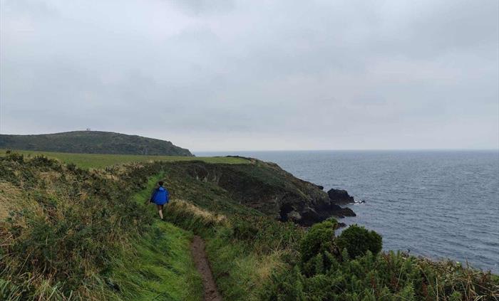 Walker on the coast path near to the cliff edge